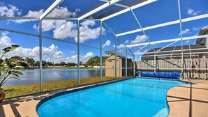 A swimming pool with a clear view of the sky and surrounding area. - Lake-view Home w/ Game Room in Orlando! (Kissimmee)