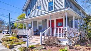 A two-story house with a red front door, white porch columns, and a covered front porch. - Mystic Refuge w/ Patio < 1 Mi to Downtown! (Mystic)