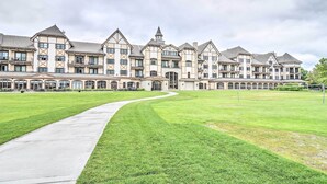 A large, multi-story building with a symmetrical facade, a central entrance, and a well-maintained lawn. - Ski-in/ski-out Getaway at Boyne Mountain Resort (Boyne Falls)