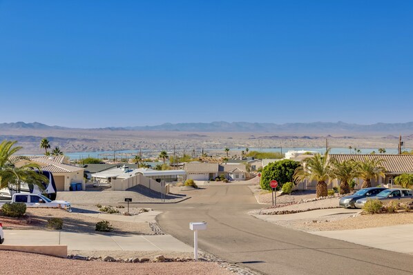 A residential area with houses, a stop sign, and a clear view of distant mountains. - Putting Green, Pool Access: Lake Havasu City Home! (Lake Havasu City)