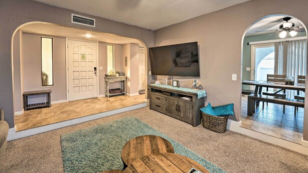 A living room with a fireplace, a television, and a dining area with a table and chairs. - 3 Mi to Water: Lake Havasu Gem w/ Fire Pit & Grill (Lake Havasu City)