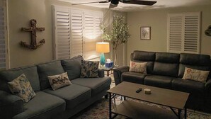 A living room with two sofas, a coffee table, a lamp, and a plant. - 1 Mi to Beach: Nokomis Home w/ Private Pool (Nokomis)