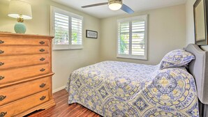 A bedroom with a bed, dresser, ceiling fan, and two windows with blinds. - 1 Mi to Beach: Nokomis Home w/ Private Pool (Nokomis)