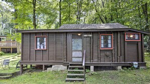 A small wooden cabin with a door labeled "WEE TOO" and a small porch area. - Rustic Hayward Cabin With Spider Lake Access! (Hayward)