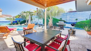 An outdoor patio with a pool, wooden ceiling, and seating. - Family Home w/ Community Perks in Peoria (Peoria)