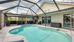 An indoor swimming pool with a glass ceiling, lounge chairs, and a covered seating area. - Bright Getaway w/ Ski Lake, 11 Miles to Dtwn Tampa (Brandon)