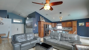 A spacious living room with two grey leather sofas, a coffee table, and a ceiling fan. - Bright Getaway w/ Ski Lake, 11 Miles to Dtwn Tampa (Brandon)