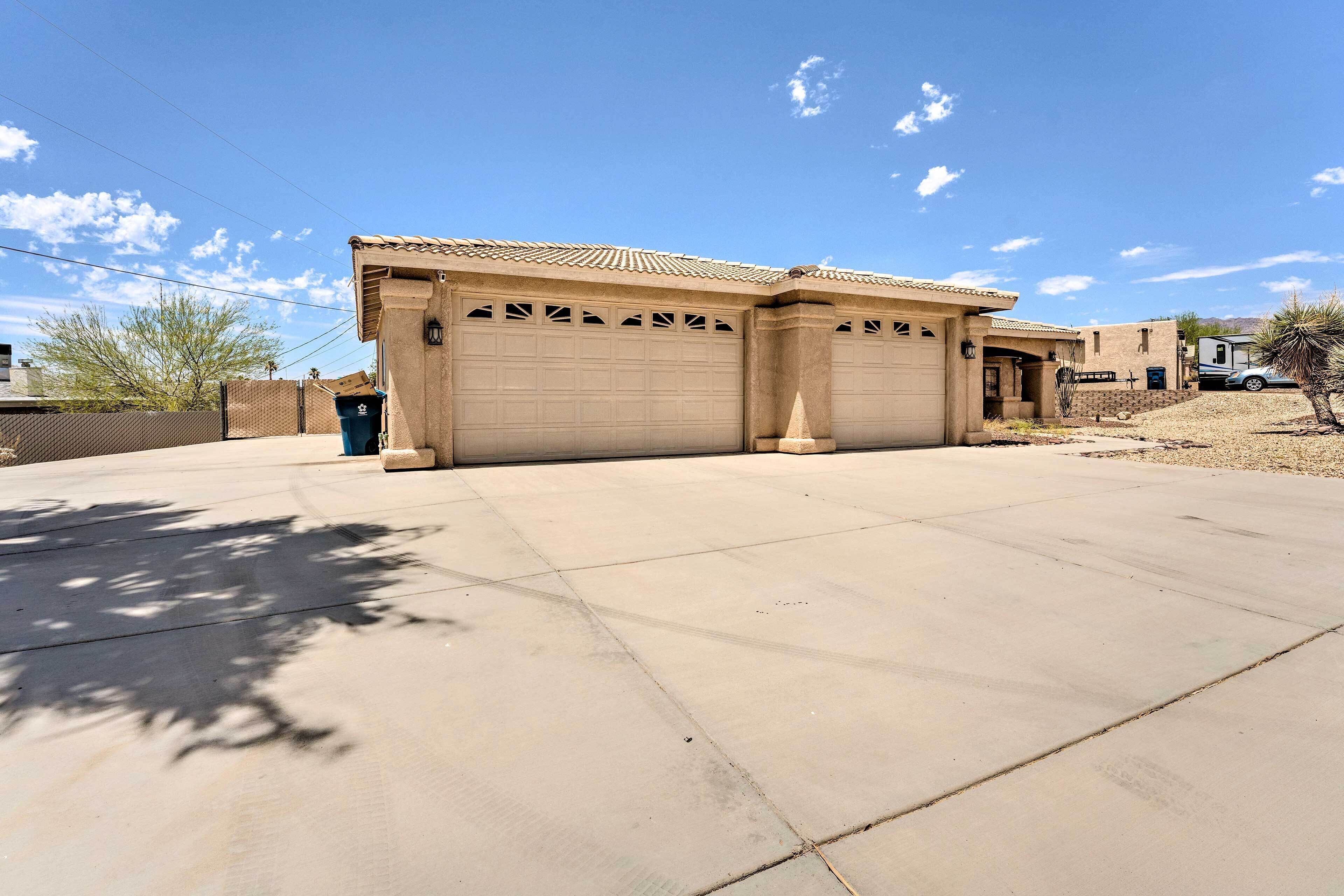 A residential property with a garage, a driveway, and a clear sky.