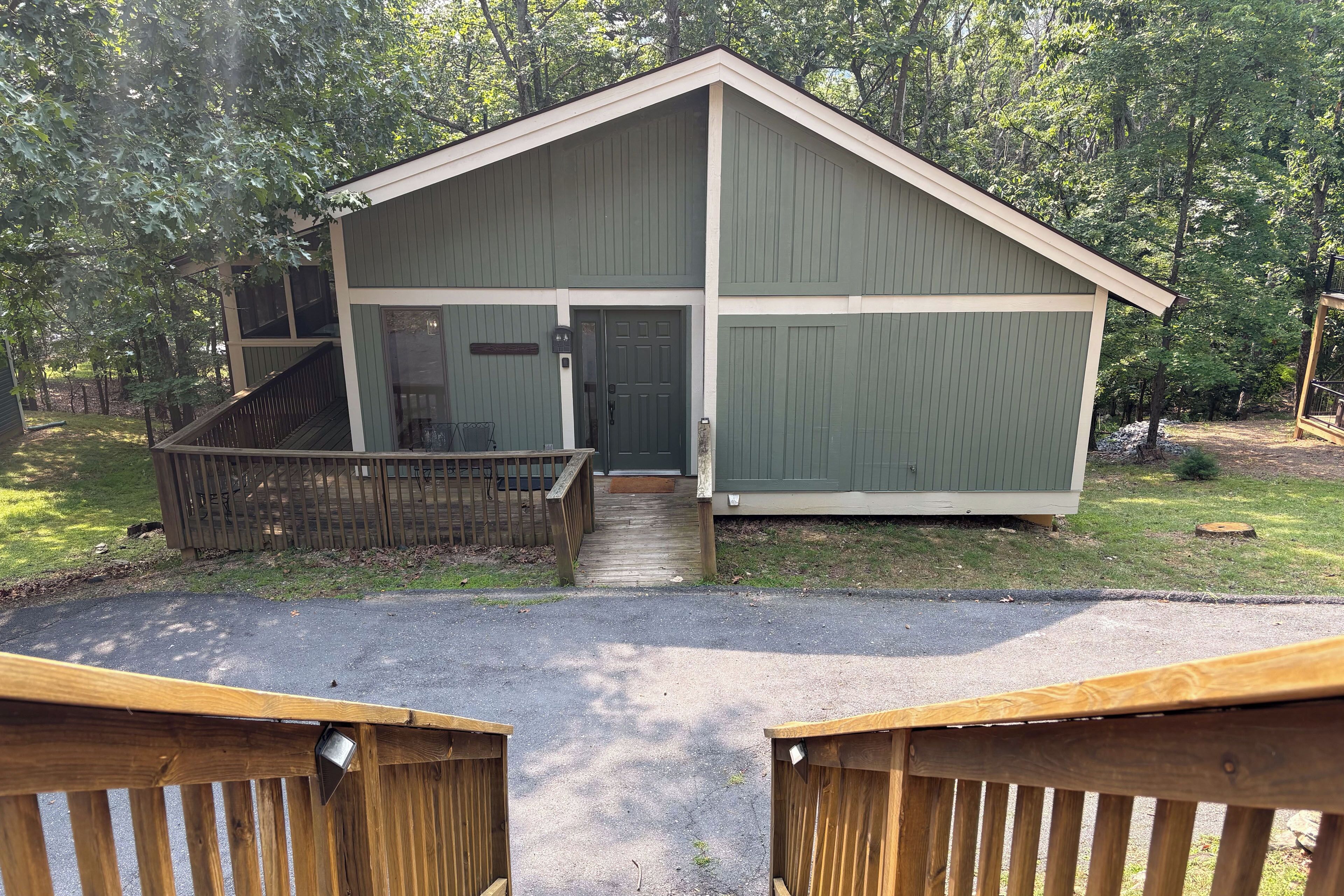 A small, single-story building with a sloped roof, a front door, and a small porch area.