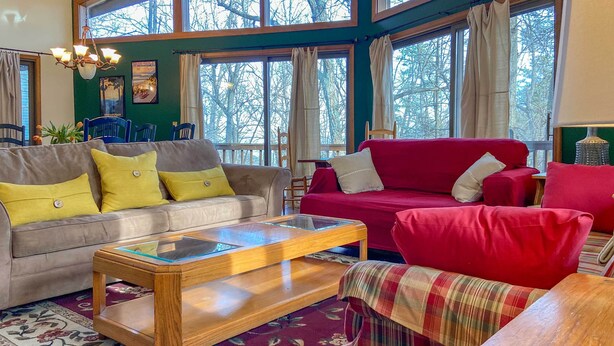 A cozy living room with a grey sofa, red sofa, and a wooden coffee table. - 'the Overlook' in Massanuttens All Season Resort (McGaheysville)