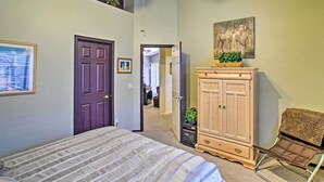 A bedroom with a bed, a wardrobe, a chair, and a ceiling fan. - Charming Anthem Home w/ Fire Pit, 1 Mi to Park! (Phoenix)