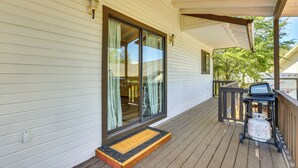 A wooden deck with a covered area, a sliding glass door, and a welcome mat. - Hike, Sled & Snowshoe! Family Retreat in Payson (Payson)