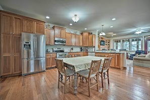 Kitchen with central island, dining table, and seating area.