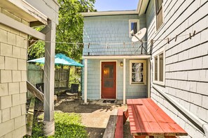 A small, light blue house with a red door, a satellite dish, and a red picnic table. - Finger Lakes Home w/ Sweeping Views and Sun Deck! (Watkins Glen)