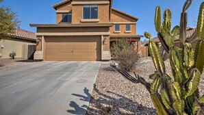 A two-story house with a garage, a driveway, and a cactus in the foreground. - Maricopa Home w/ Outdoor Seating, 2 Mi to Golf! (Maricopa)