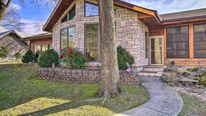 A stone house with a large window and a stone staircase leading to the front door. - Waterfront Hollister Retreat w/ Dock & Game Room! (Hollister)