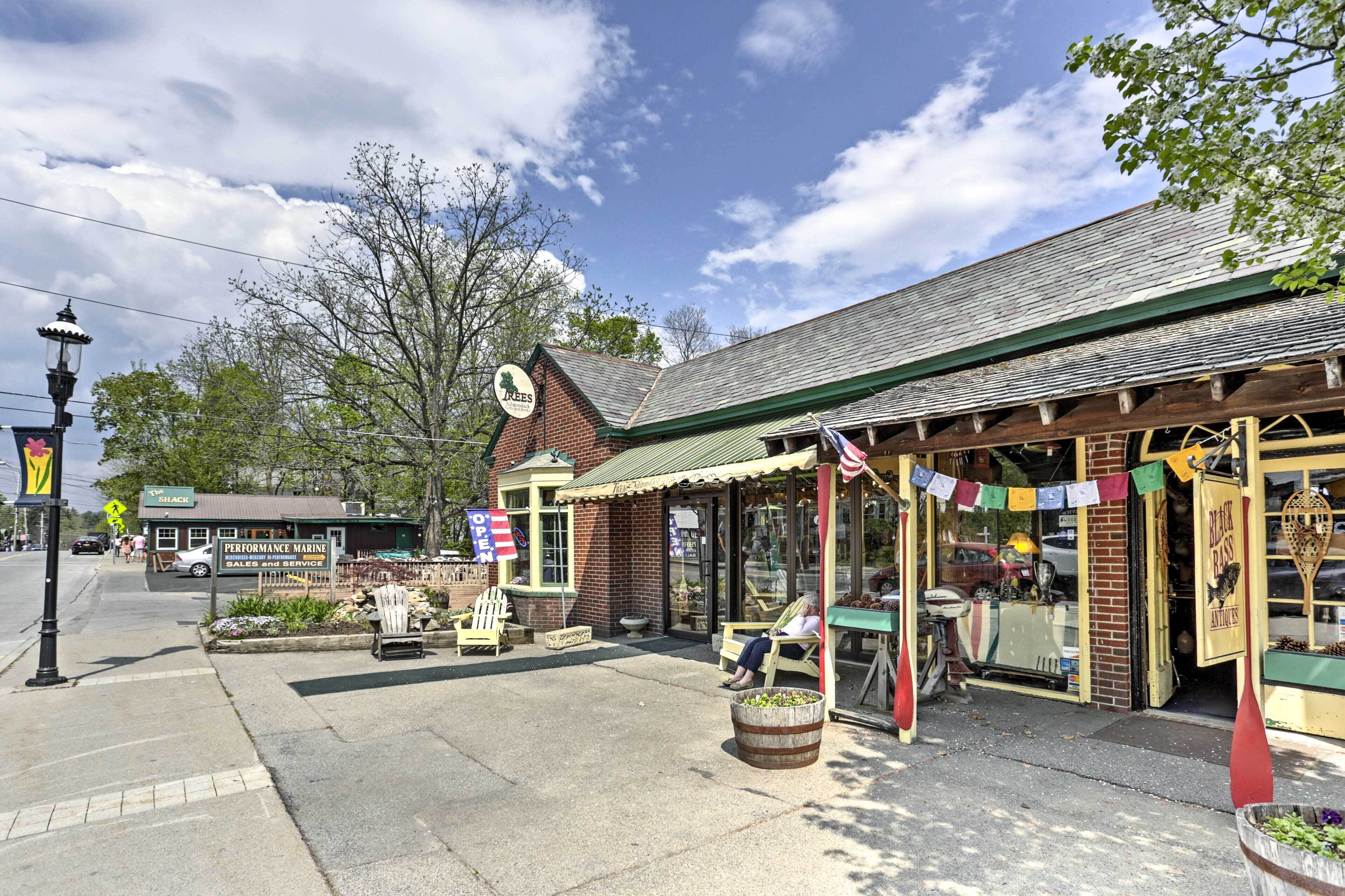 A storefront with a green awning, a sign for 'Performance Marine Sales and Service', and a 'Shack' sign in the background.