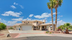 A two-story house with a garage, a covered patio, and a driveway. - 3 Mi to Lake Havasu: Luxe Home w/ Pool & Spa! (Lake Havasu City)