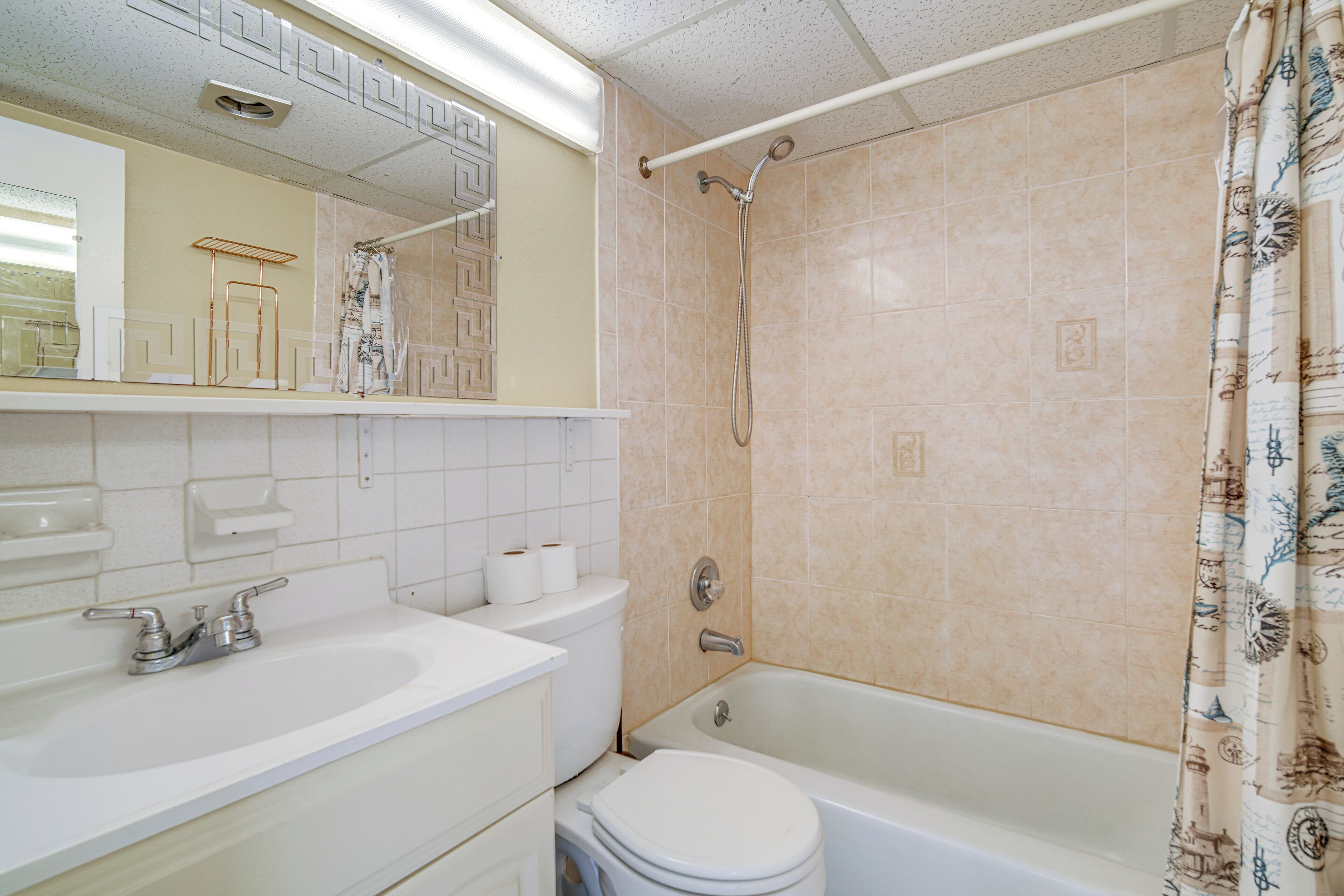 A bathroom with a sink, toilet, and bathtub.