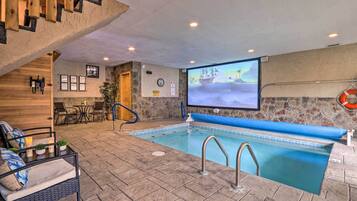 Relax by the pool, surrounded by a seating area with a wicker chair and table.
