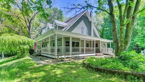 A large, single-story house with a wrap-around porch and a chimney. - Huge Family Home w/ Pool - 13 Mi to Lake Michigan! (La Porte)