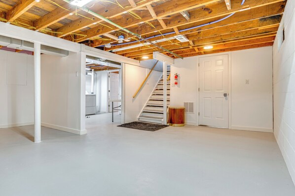 A spacious room with a wooden ceiling, white walls, and a white floor. - Peaceful Speedway Retreat Near Downtown Indy (Indianapolis)