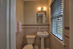 A bathroom with a toilet, sink, and window with blinds. - Lexington Family Home ~ 2 Miles to UK Campus! (Lexington)