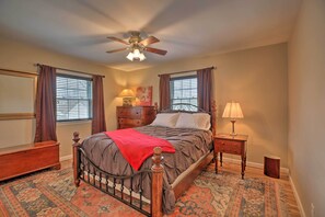 A bedroom with a bed, a nightstand, a dresser, a ceiling fan, and a window with curtains. - Lexington Family Home ~ 2 Miles to UK Campus! (Lexington)