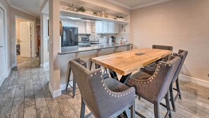 A modern kitchen with a wooden dining table and upholstered chairs. - Walk to Beach: Lake Havasu Condo w/ Pool Access (Lake Havasu City)