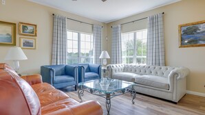 A living room with a glass coffee table, blue and white sofas, and a leather couch. - 'fox Ridge Farmhouse' - Hill Country Getaway! (San Marcos)
