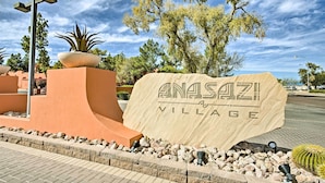 A large sign for Anasazi Village with a desert landscape in the background. - Condo w/ Pool Access, 8 Mi to Phoenix Mtn Preserve (Phoenix)