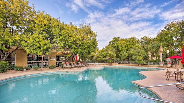 A swimming pool with lounge chairs and umbrellas, surrounded by trees and buildings. - Condo w/ Pool Access, 5 Mi to Tempe Diablo Stadium (Tempe)