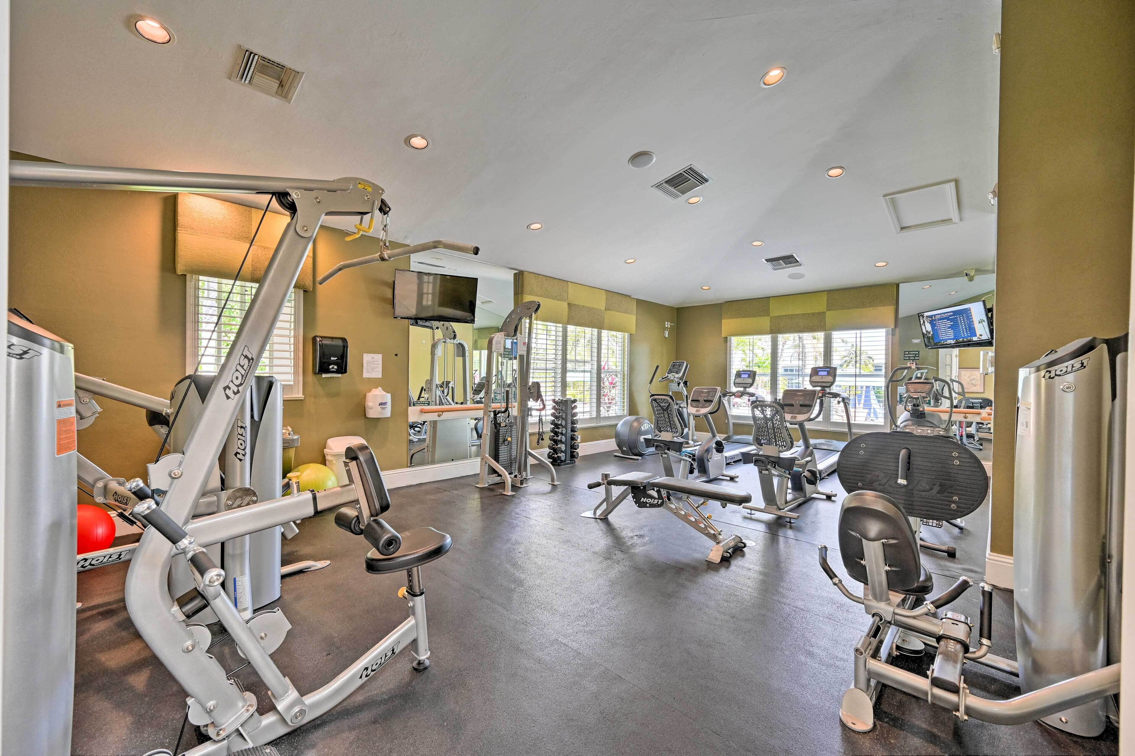 A gym with various exercise equipment, including weight machines and cardio machines.