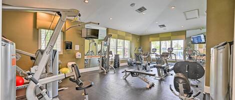 A gym with various exercise equipment, including weight machines and cardio machines.