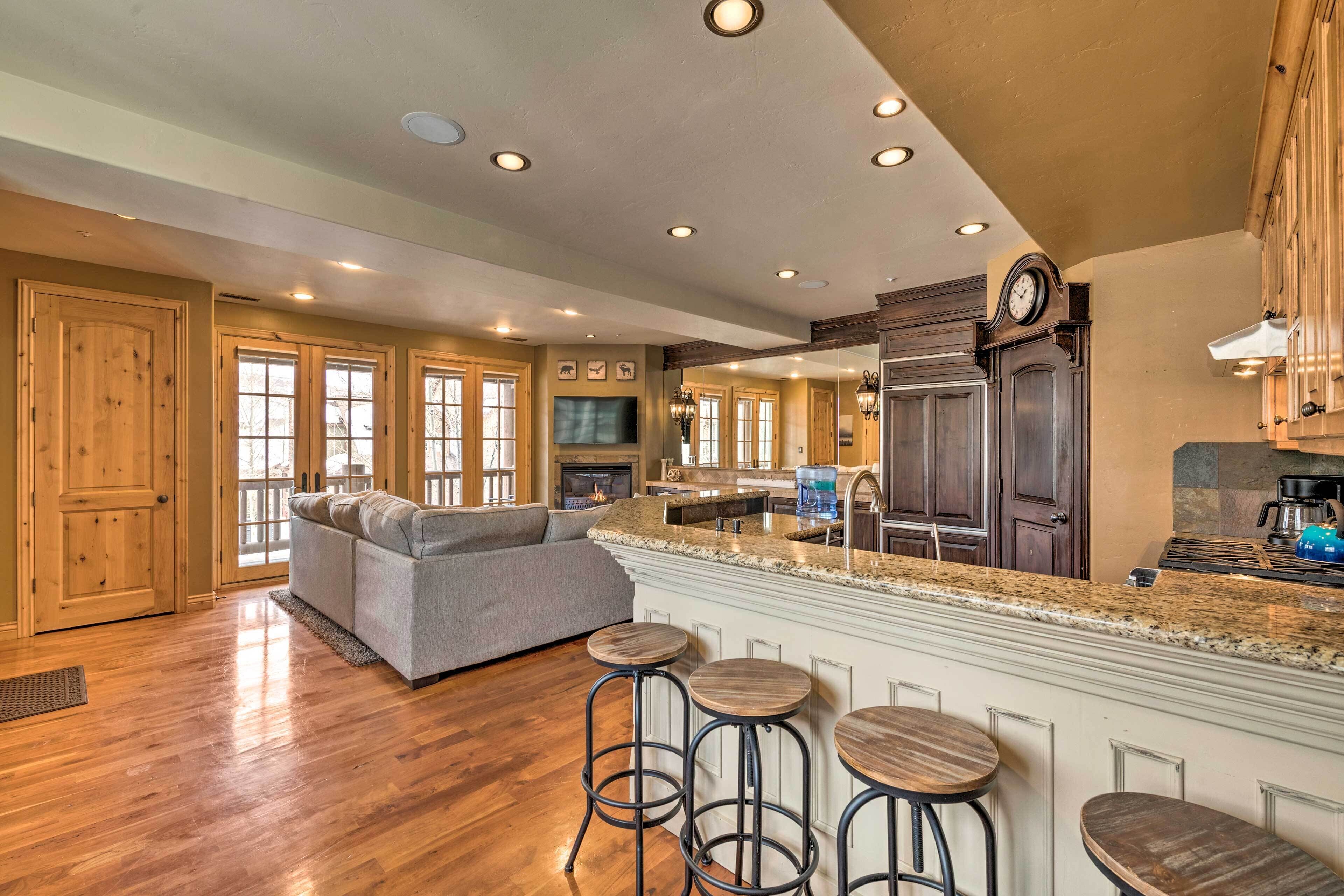 A spacious kitchen with a large island, wooden cabinets, and a built-in oven.