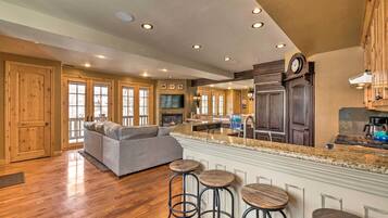 A spacious kitchen with a large island, wooden cabinets, and a built-in oven.
