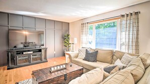 A modern living room with a sofa, coffee table, and entertainment unit.