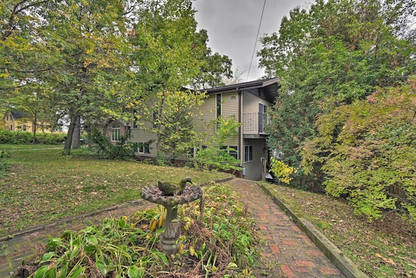 A residential house with a brick pathway leading to the front door.