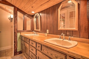 A wooden bathroom with two sinks, a large mirror, and a cabinet with drawers. - Tranquil Smoky Mountain Cabin w/ Porch & Fire Pit (Newport)