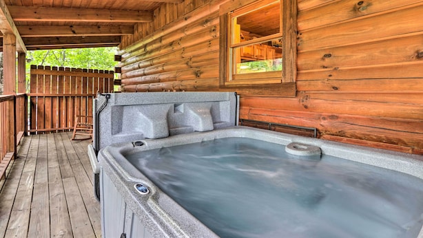 A wooden cabin with a hot tub on a wooden deck. - Cabin w/ Deck + Fireplace < 3 Mi to Dollywood! (Pigeon Forge)
