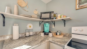 A kitchen with a granite countertop, a coffee maker, a microwave, and a stove. - Omaha Apartment 3 Mi to Cricket Creek Marina! (Omaha)