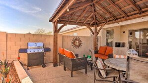 An outdoor patio with a grill, wicker furniture, and a covered seating area. - 2 Mi to State Farm Stadium: Phoenix Retreat (Phoenix)