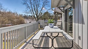 A covered patio with a table and chairs, a potted plant, and a view of the surrounding area. - Downtown Brevard Retreat With Fire Pit & Deck! (Brevard)