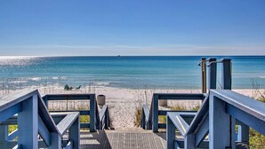 A wooden boardwalk leading to a sandy beach with a clear blue sky. - Gulf Coast Getaway w/ Balcony & Resort Amenities! (Panama City Beach)