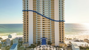 A high-rise hotel with multiple balconies, a beach view, and a water slide. - Gulf Coast Getaway w/ Balcony & Resort Amenities! (Panama City Beach)