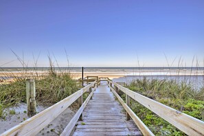 A wooden boardwalk leading to a beach with a clear sky. - Beachfront Resort Condo w/ Panoramic Ocean Views! (New Smyrna Beach)