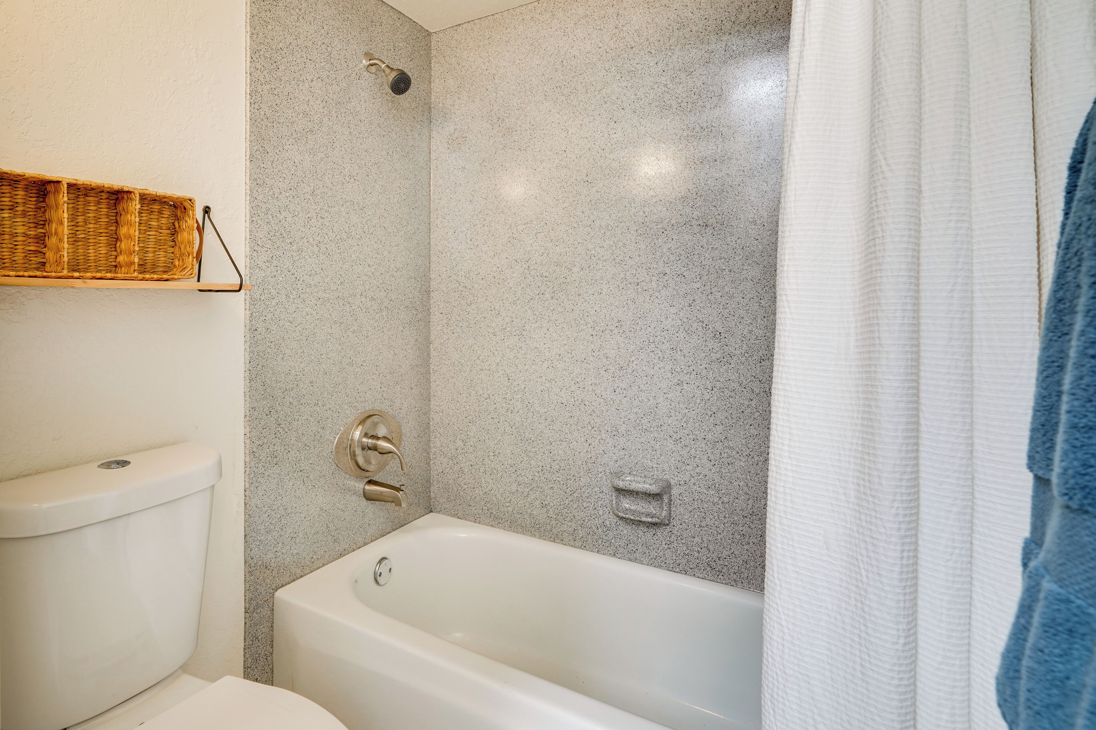 Ein Badezimmer mit einer weißen Badewanne, einer Toilette und einer Dusche.