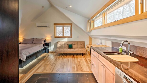 A compact, modern loft bedroom with a built-in bed, a sofa, and a kitchenette. - Updated Boulder Studio ~ 1 Mi to Pearl Street (Boulder)