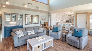 A spacious living room with a sofa set, a coffee table, and a dining area with chairs and a table. - Idyllic Coastal Haven - Whale Watch in Depoe Bay! (Depoe Bay)
