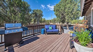 A deck with a grill, seating, and a planter. - 1 Mi to Hiking: Chic Show Low Escape w/ Fire Pit! (Show Low)